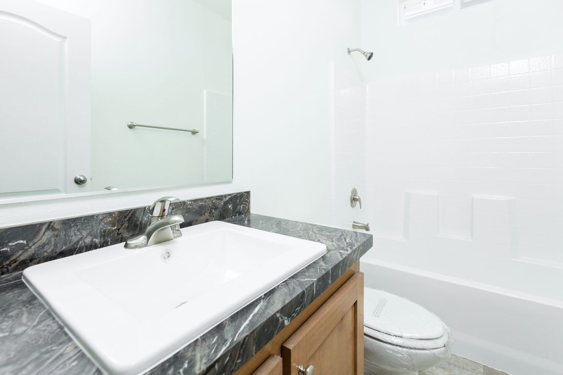 The 2025 COLUMBIA RIVER Guest Bathroom. This Manufactured Mobile Home features 4 bedrooms and 2 baths.