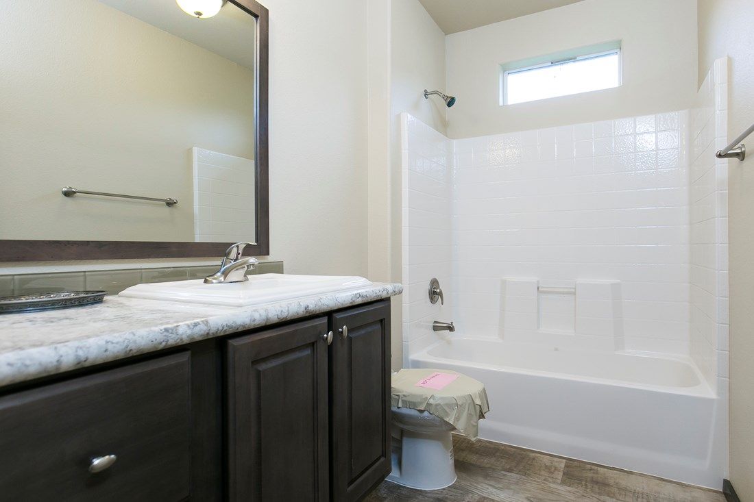 The 2023 COLUMBIA RIVER Master Bathroom. This Manufactured Mobile Home features 3 bedrooms and 2 baths.